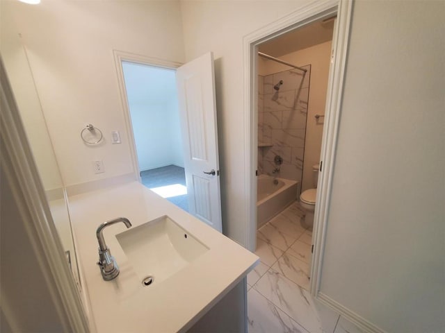 bathroom featuring toilet, marble finish floor, tub / shower combination, and vanity