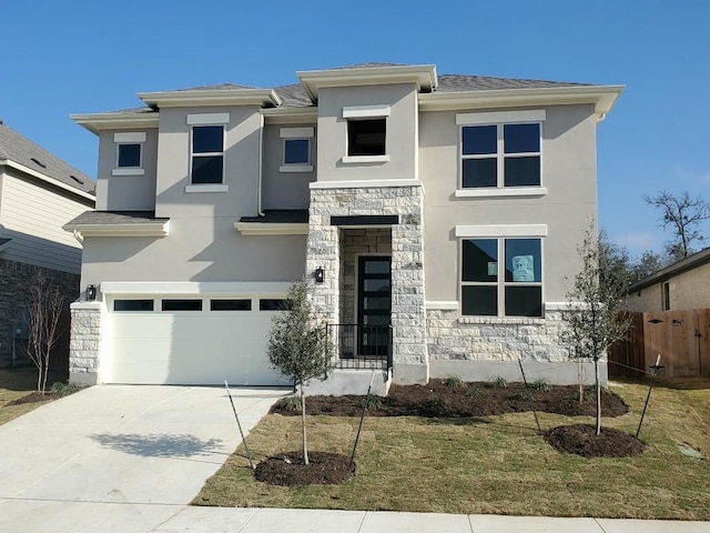 view of front of property featuring stone siding, concrete driveway, and stucco siding