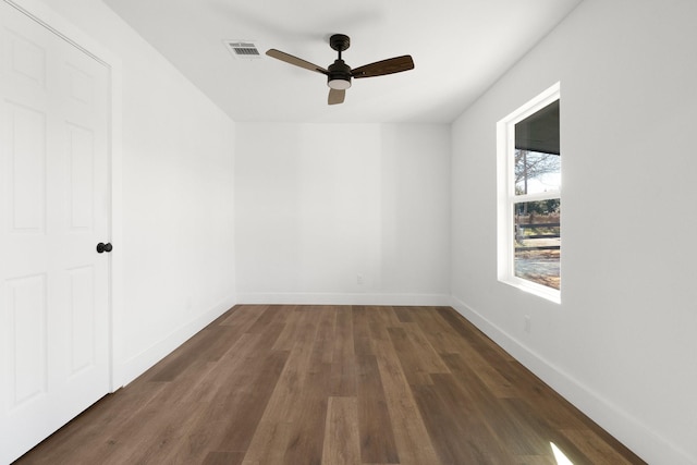 unfurnished room with dark hardwood / wood-style floors and ceiling fan