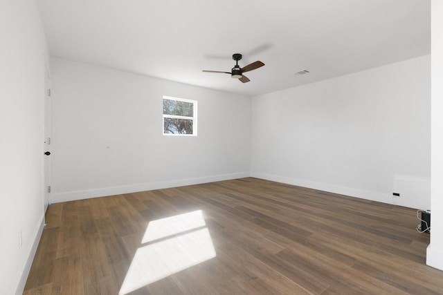 spare room featuring dark hardwood / wood-style floors and ceiling fan