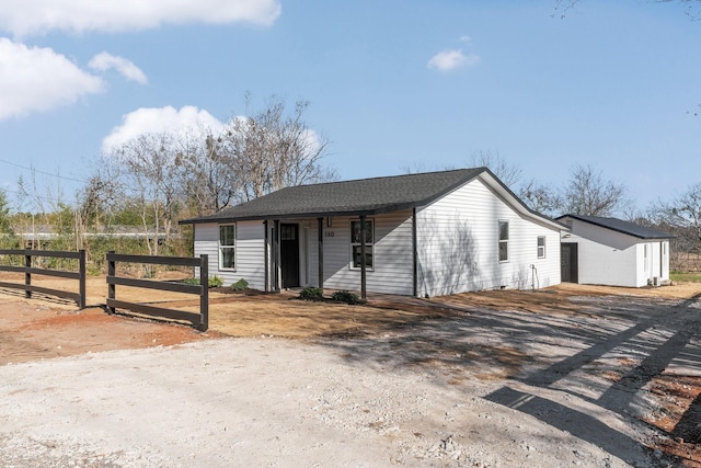 single story home featuring a shed