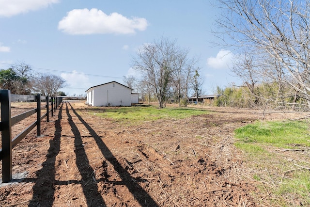 view of yard with a rural view and an outbuilding