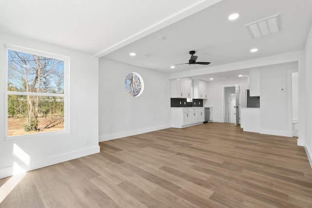 unfurnished living room with ceiling fan and light hardwood / wood-style floors