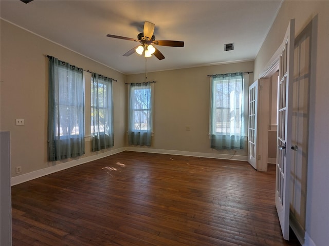 empty room featuring dark wood-type flooring and ceiling fan