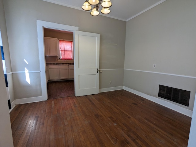 unfurnished dining area featuring crown molding, dark hardwood / wood-style flooring, and a chandelier