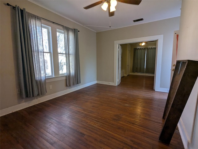 spare room featuring dark wood-type flooring and ceiling fan