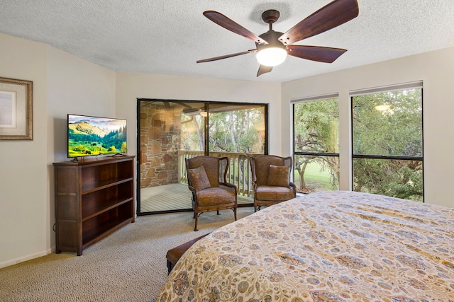 bedroom featuring light colored carpet, a textured ceiling, and ceiling fan