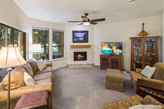 carpeted living room with ceiling fan