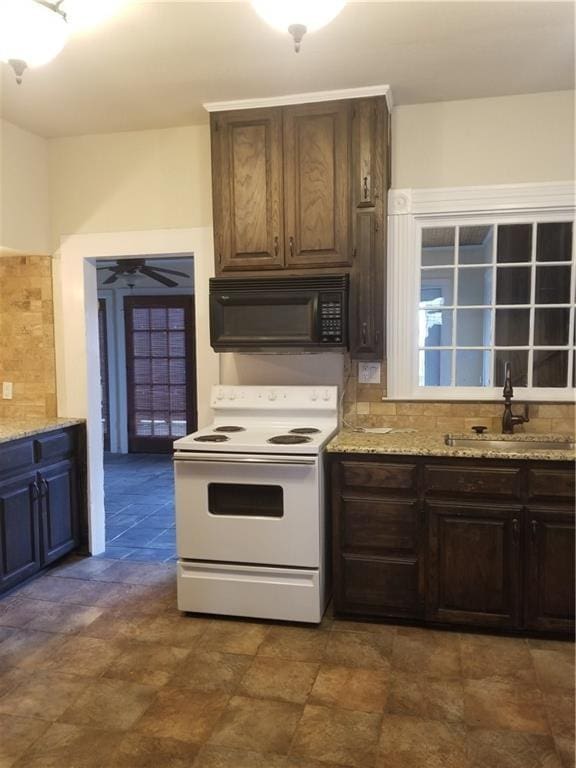 kitchen featuring white electric stove, sink, dark brown cabinetry, and ceiling fan