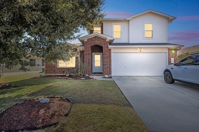 front facade featuring a yard and a garage