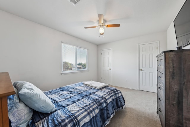 bedroom featuring light colored carpet and ceiling fan