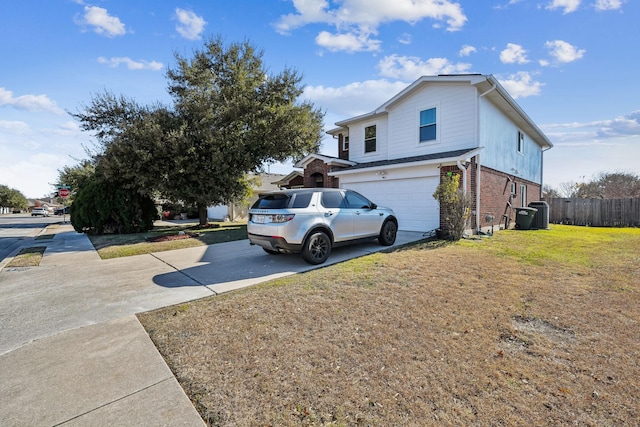 view of side of property with a garage and a lawn