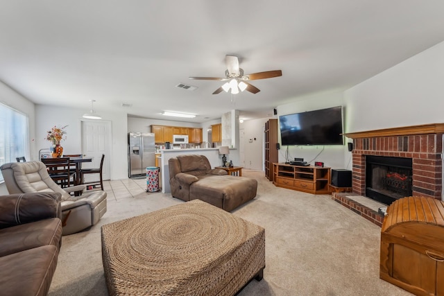 carpeted living room featuring ceiling fan and a brick fireplace