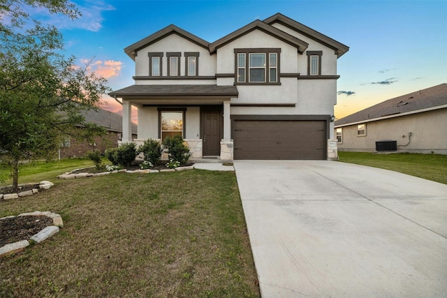 view of front facade with driveway, a front lawn, an attached garage, and stucco siding