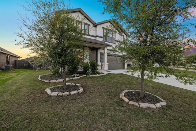 english style home with a garage, central AC, and a lawn