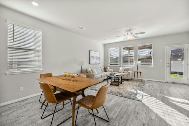 dining area featuring ceiling fan and light wood-type flooring