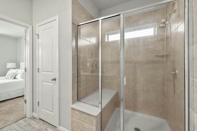 bathroom with wood-type flooring and a shower with shower door