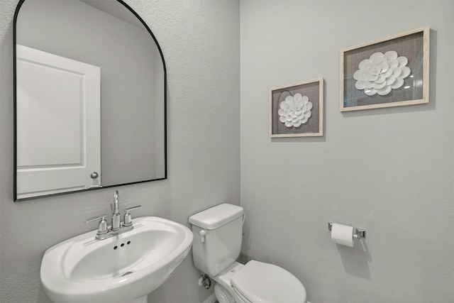 bathroom featuring sink and toilet