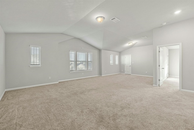 19004 Quebrada Dr, Pflugerville, TX 78660 - empty room featuring light carpet and vaulted ceiling