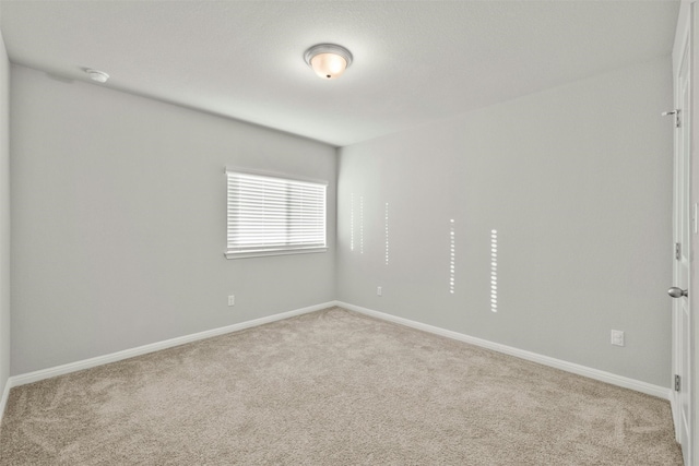 spare room with light carpet