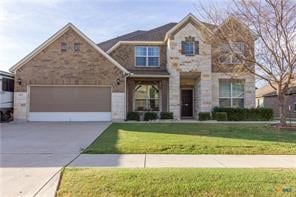 view of front of home with a garage and a front yard