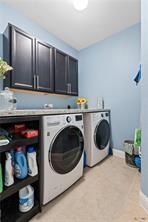 laundry area featuring cabinets and washer and clothes dryer