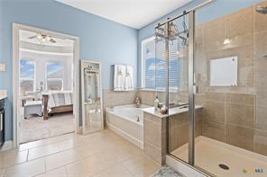 bathroom with tile patterned floors, plenty of natural light, independent shower and bath, and vanity