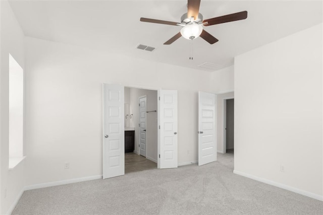 unfurnished bedroom featuring light carpet, baseboards, visible vents, and a ceiling fan