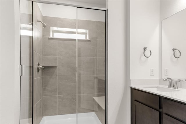 bathroom with a shower stall and vanity