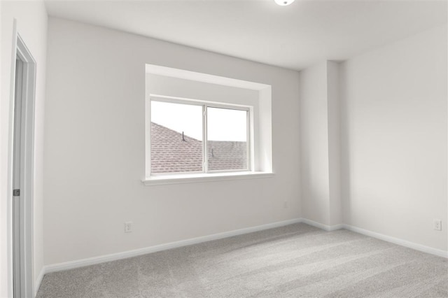 unfurnished room with baseboards and carpet flooring