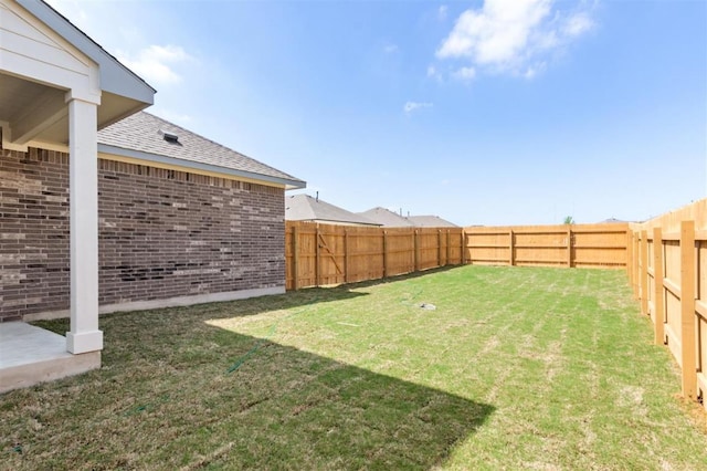 view of yard with a fenced backyard