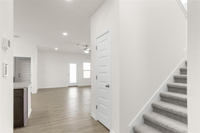 staircase featuring recessed lighting, baseboards, visible vents, ceiling fan, and wood finished floors