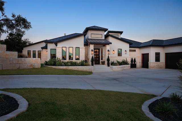 view of front of home featuring a garage and a front lawn