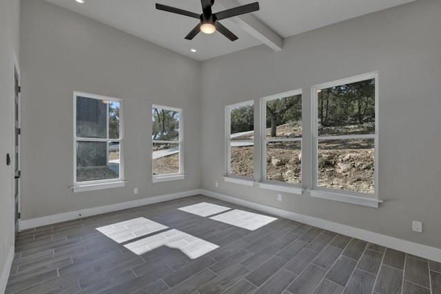 empty room featuring ceiling fan and beam ceiling