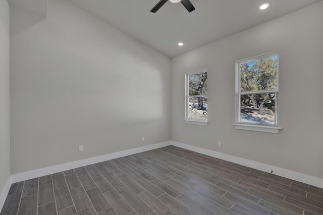 empty room featuring dark wood-type flooring, ceiling fan, and vaulted ceiling