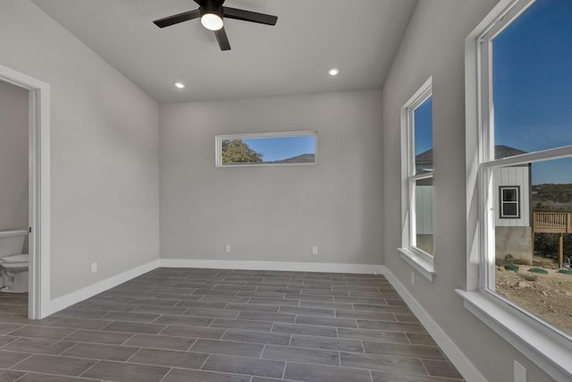 unfurnished room featuring ceiling fan and dark hardwood / wood-style floors