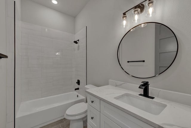 full bathroom with vanity, toilet, and tiled shower / bath combo