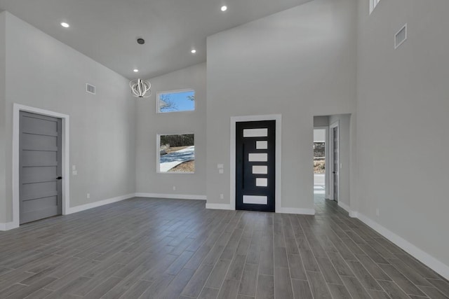 entryway with an inviting chandelier and a towering ceiling