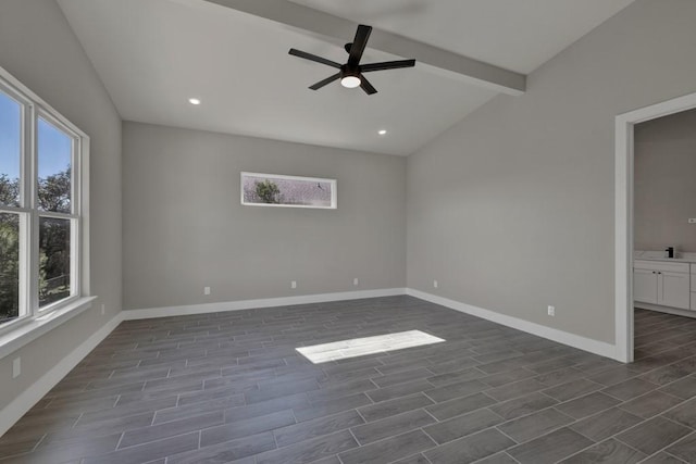 unfurnished room featuring ceiling fan and lofted ceiling with beams