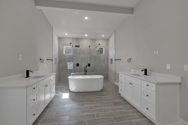 bathroom with vanity, beam ceiling, and separate shower and tub