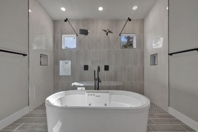 bathroom featuring tile walls, tile patterned flooring, a wealth of natural light, and shower with separate bathtub