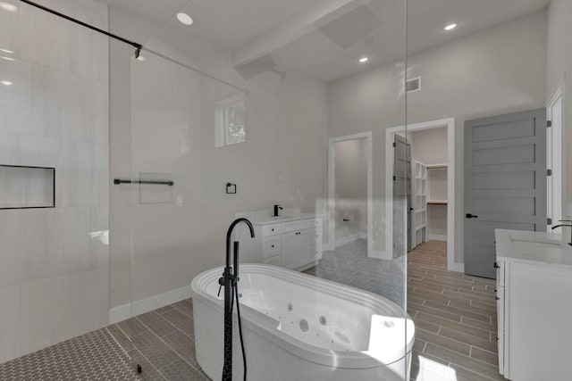 bathroom with vanity and a bath