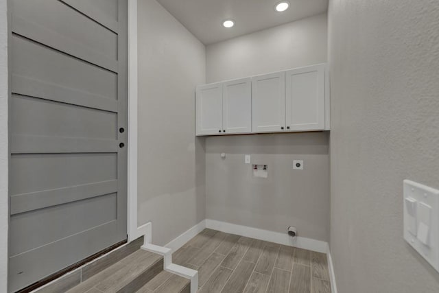 washroom featuring cabinets, hookup for a washing machine, and hookup for an electric dryer