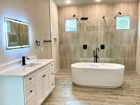 bathroom featuring vanity and plus walk in shower