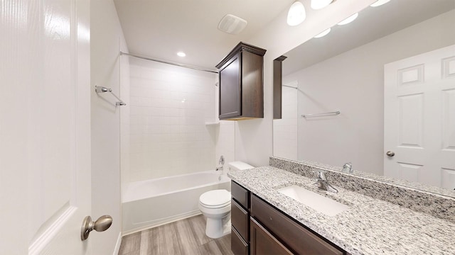 full bathroom with hardwood / wood-style flooring, vanity, toilet, and shower / bathing tub combination