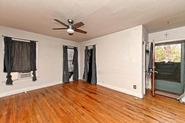 206 M L K Dr Unit B, Elgin, TX 78621 - spare room featuring a ceiling fan, cooling unit, baseboards, and light wood-style flooring