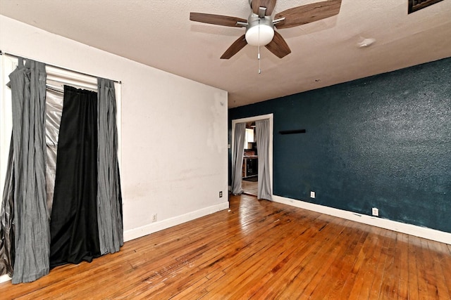 unfurnished room with hardwood / wood-style floors and ceiling fan