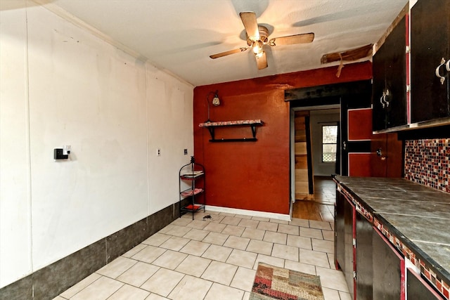 kitchen with light tile patterned flooring, ceiling fan, and decorative backsplash