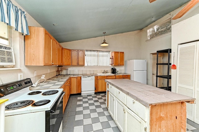 kitchen featuring sink, tile counters, a kitchen island, pendant lighting, and white appliances