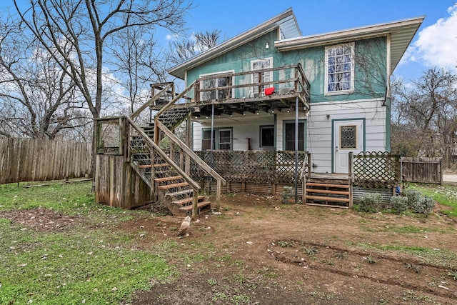 rear view of property featuring a deck